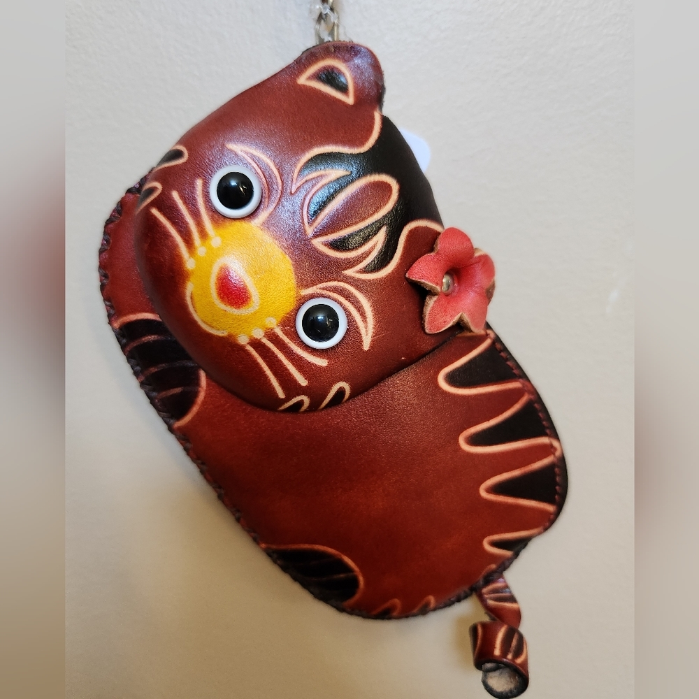A painted leather cat shaped wristlet